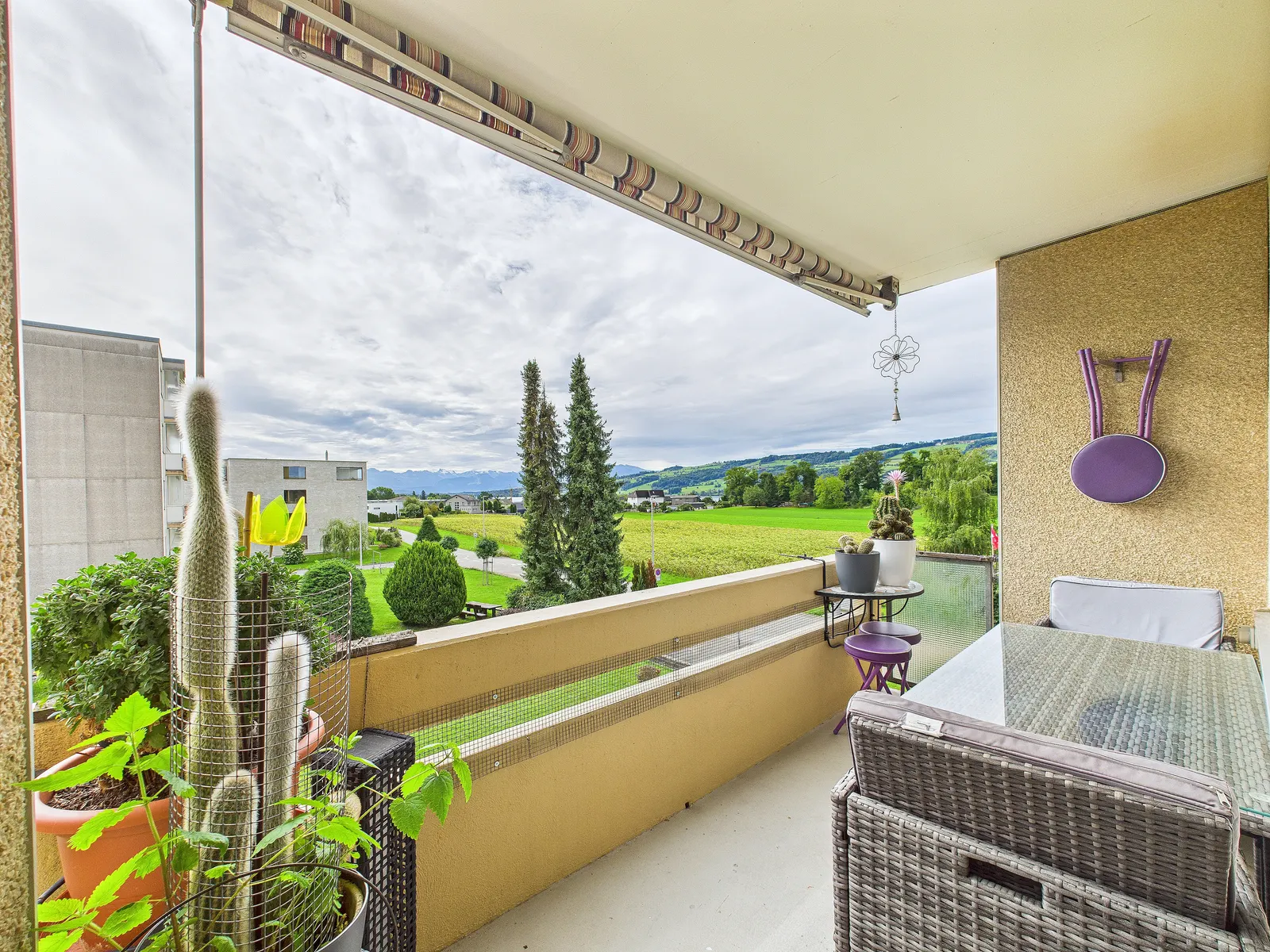Flat sold in Hitzkirch LU: balcony with a wide view over meadows and hills